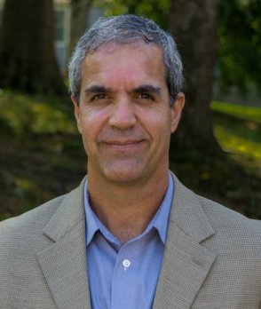 Headshot of Dr. Mike Rawlins in front of forested background