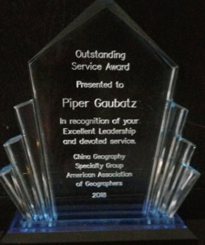 Photograph of crystal award presented to Dr. Gaubatz, with award text etched into crystal