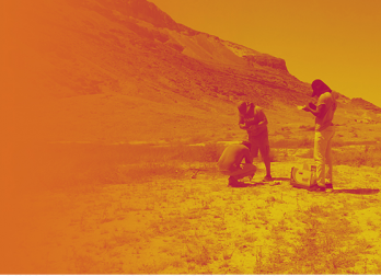 Yellow-Orange tone black and white photo of students conducting fieldwork in desert